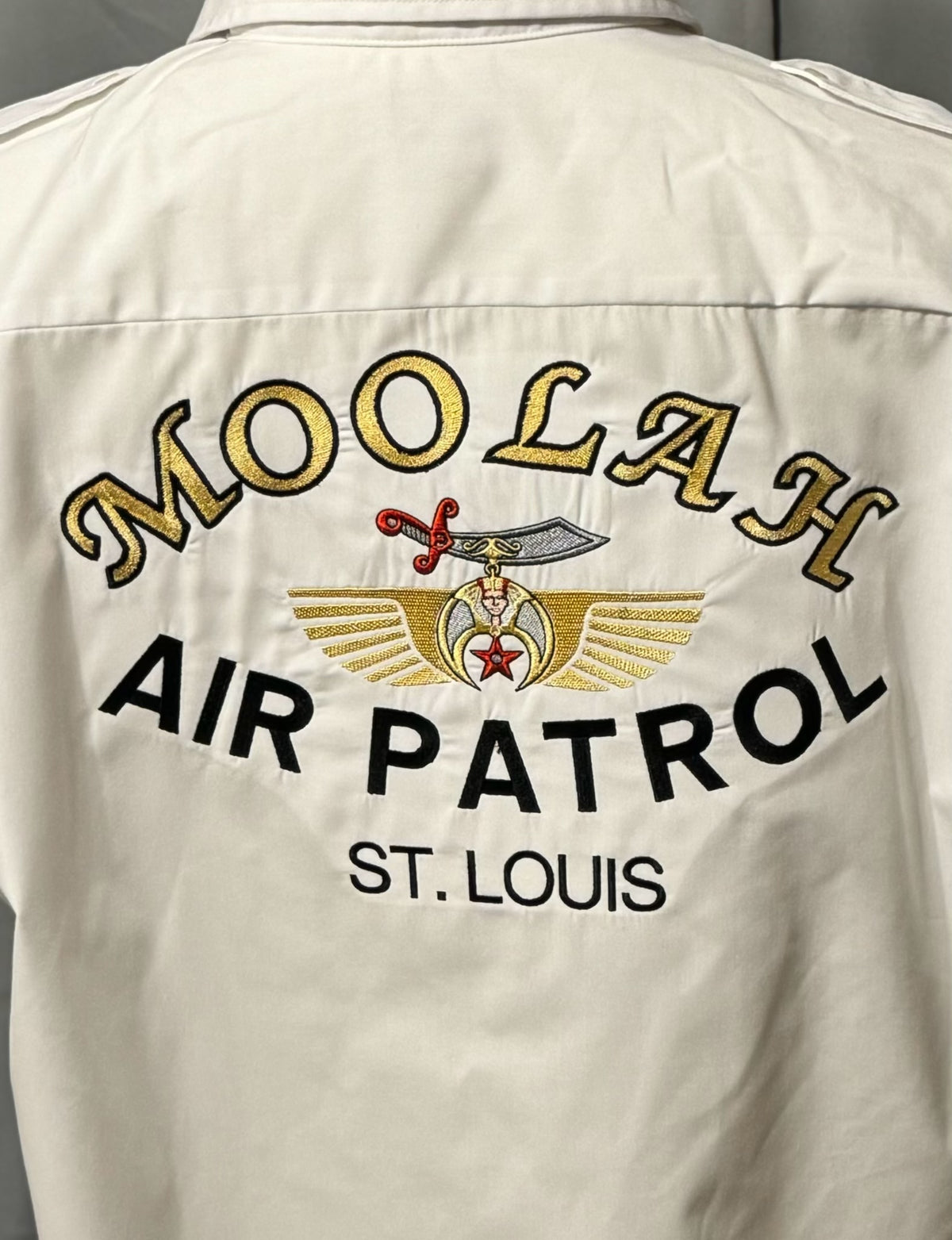 a white shirt with gold text on it