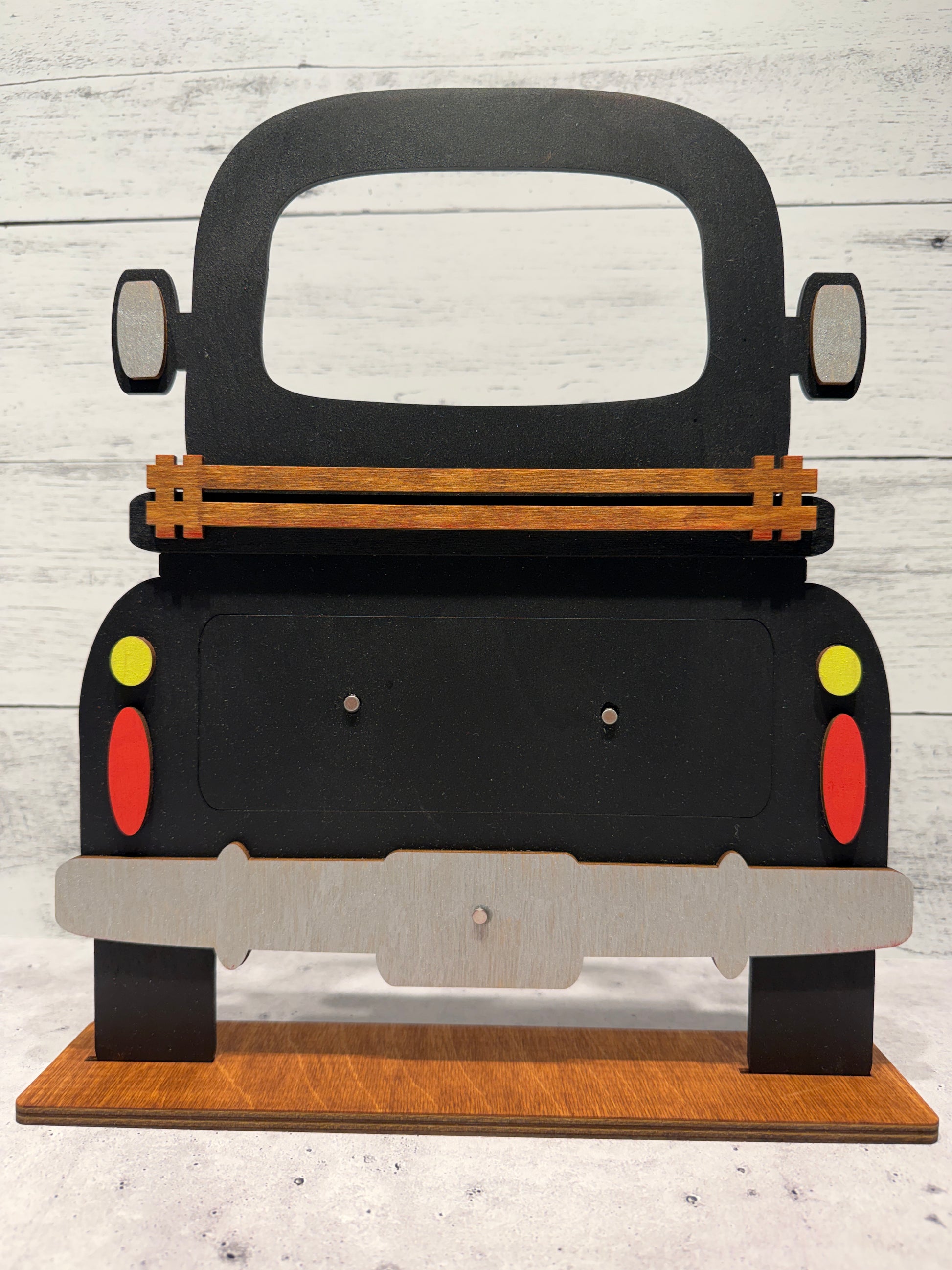 Black wooden truck on wooden stand