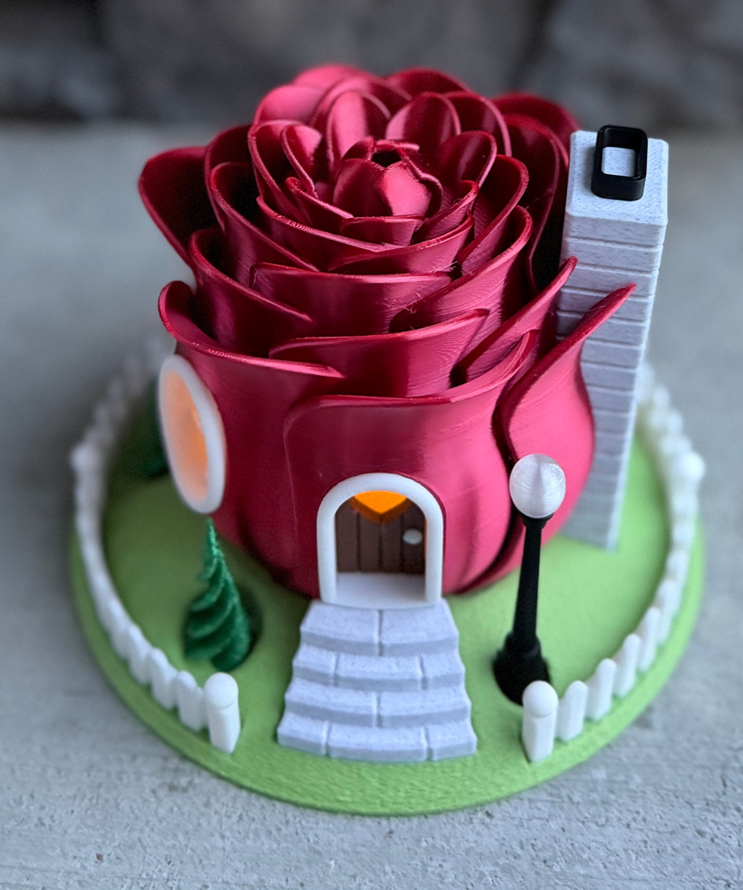 Red rose-shaped house with a small street scene