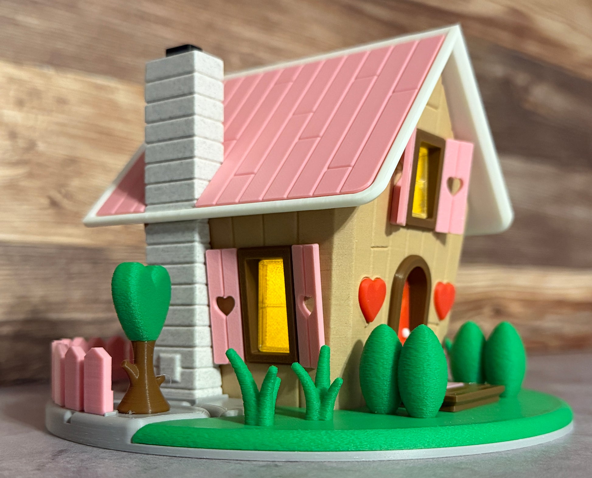 Toy house with a pink roof and heart-shaped windows