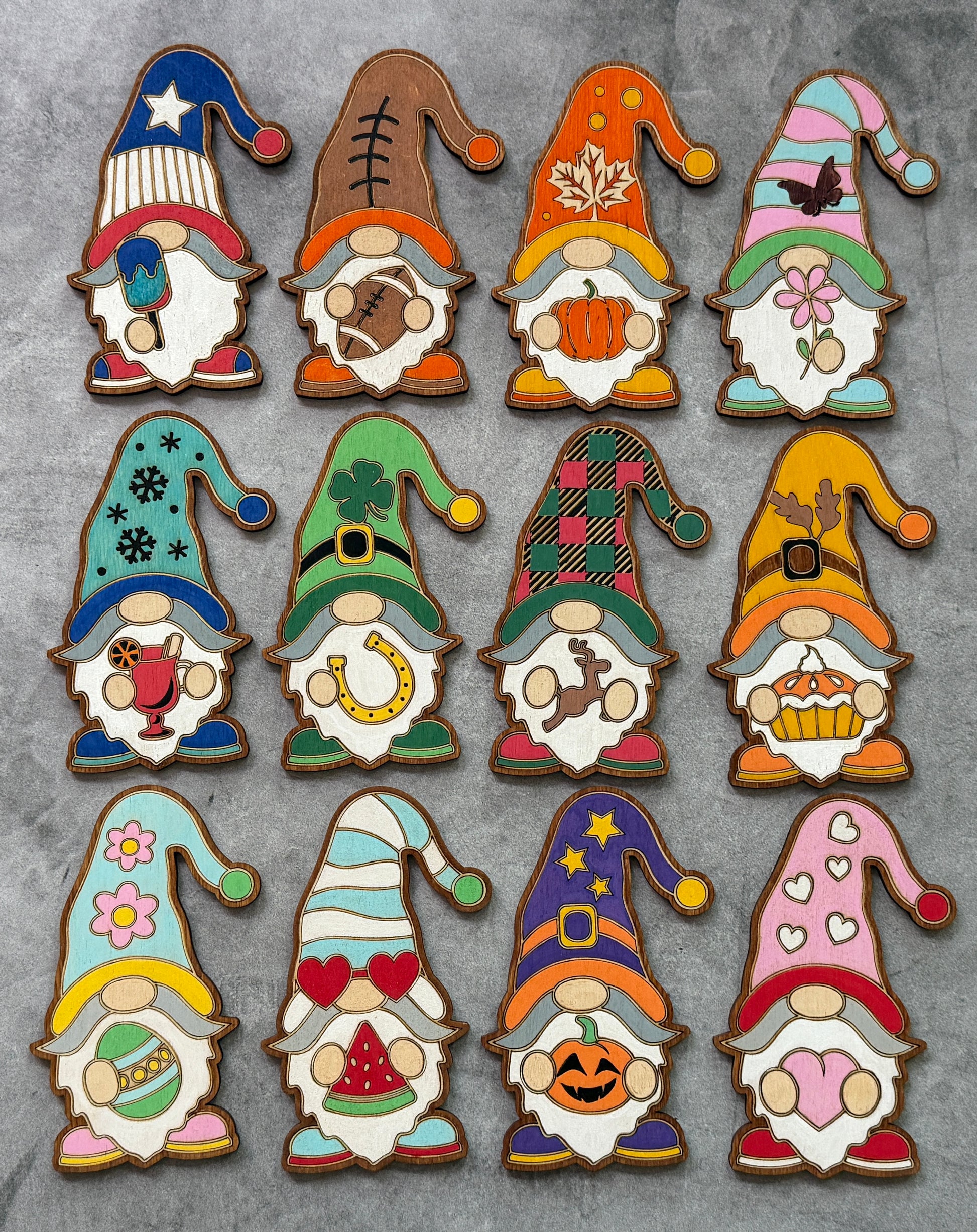 Set of colorful gnome-shaped cookies with various designs on a gray background
