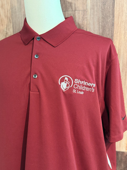 a red polo shirt on a mannequin