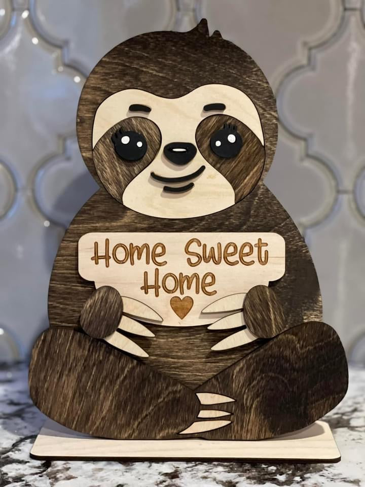 a wooden sloth with a sign