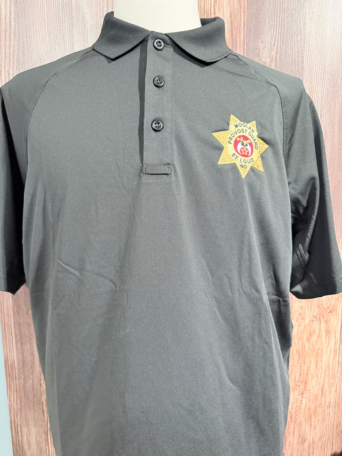 a grey polo shirt with a yellow star on it