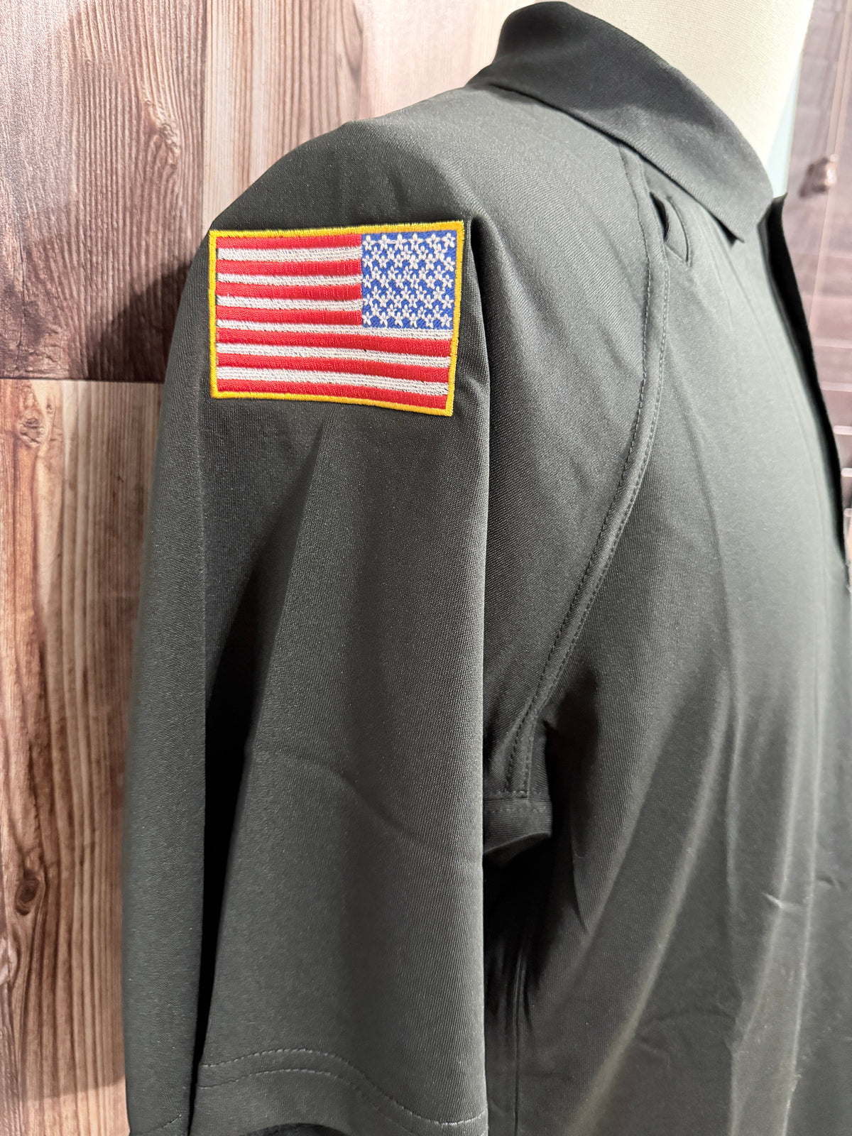 a black shirt with a flag patch on the sleeve