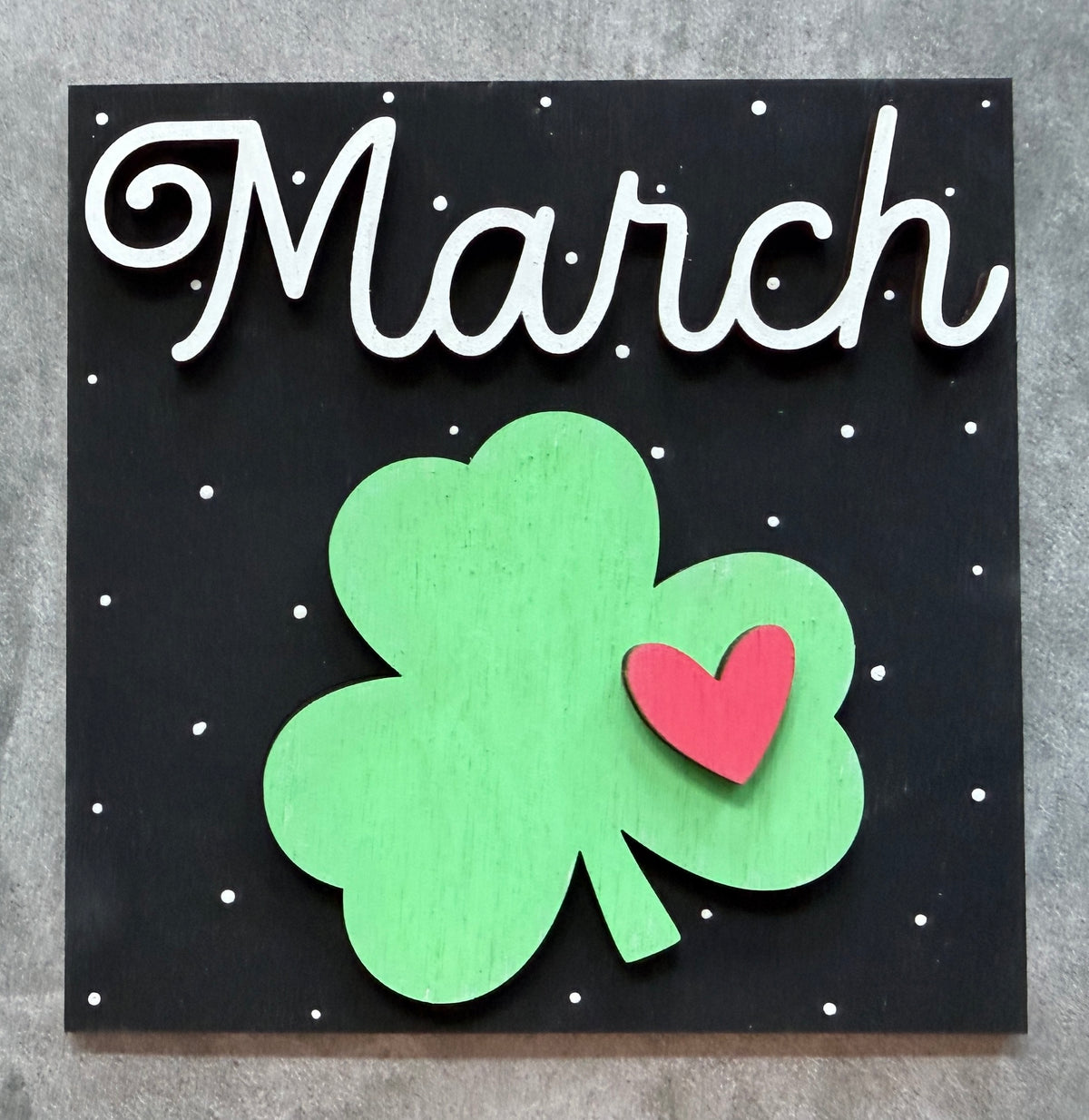 a sign with a clover and a heart