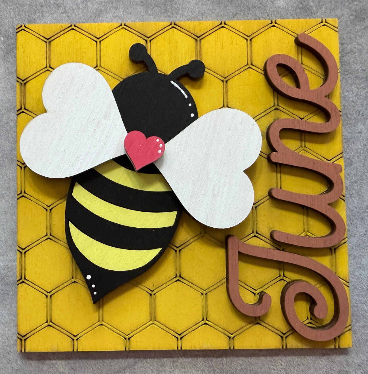 a bee on a yellow square