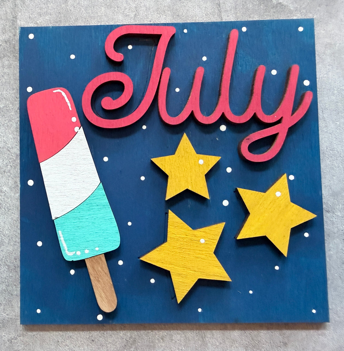 a sign with a popsicle and stars on it