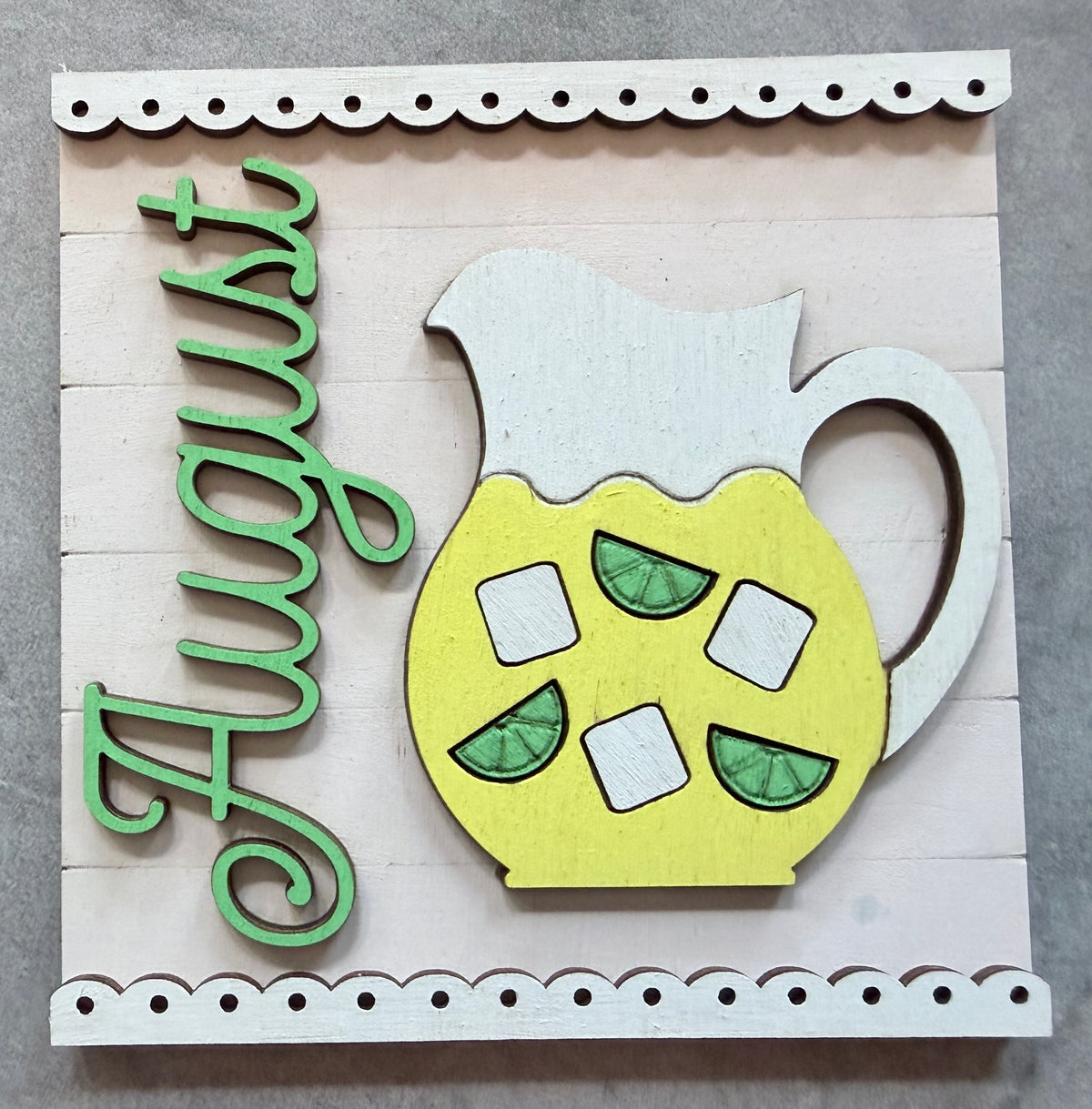 a wooden sign with a pitcher of lemonade and words