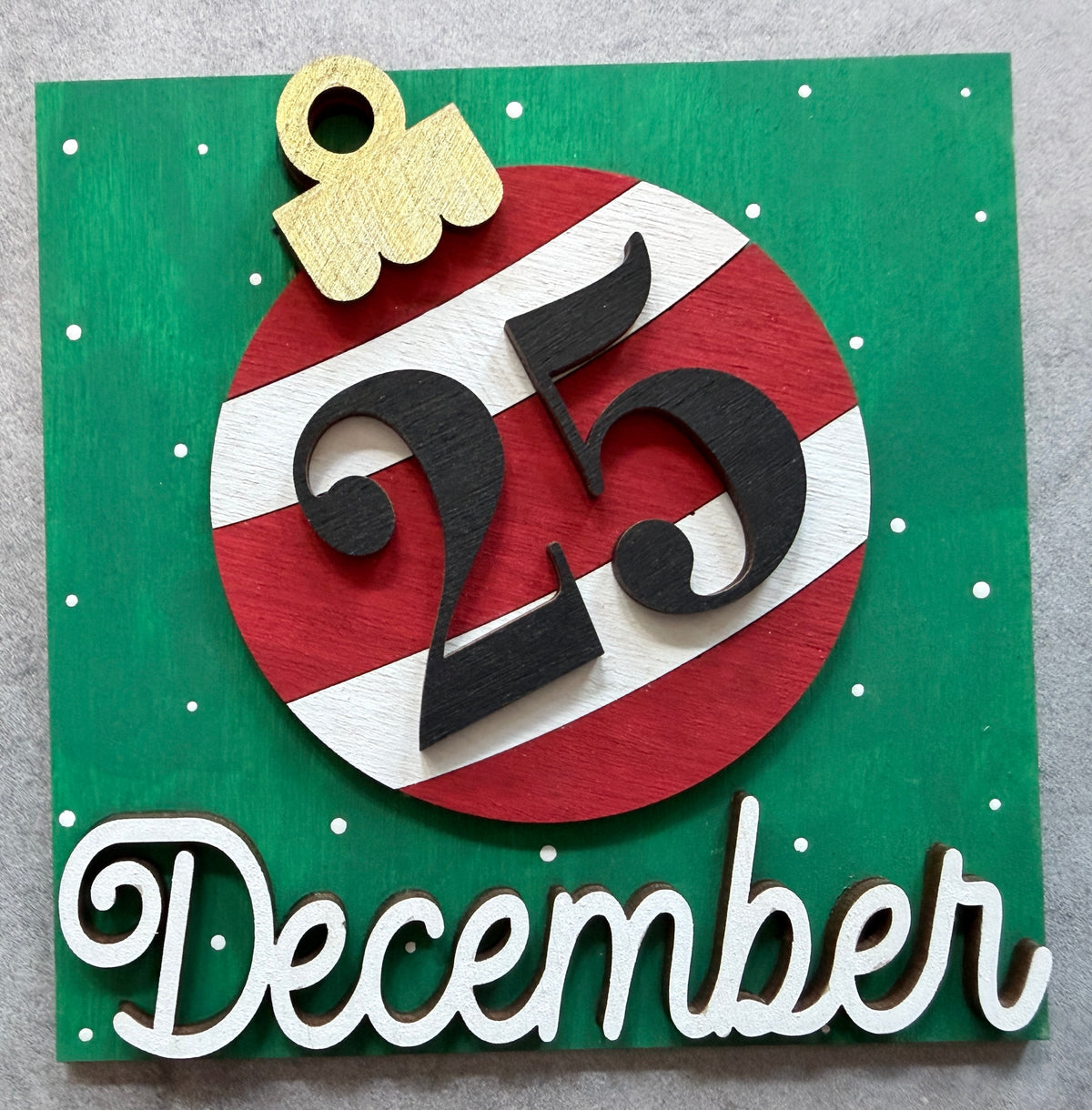 a green and red sign with a number and a gold and white text