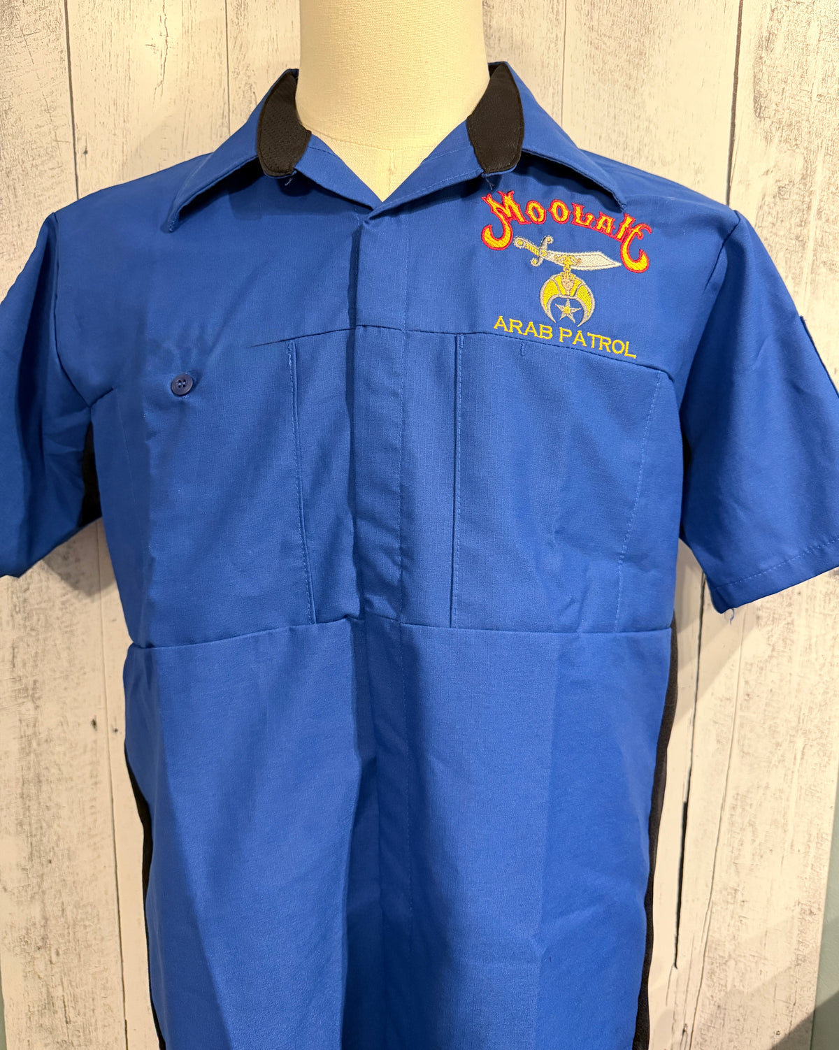 a blue shirt with a logo on it