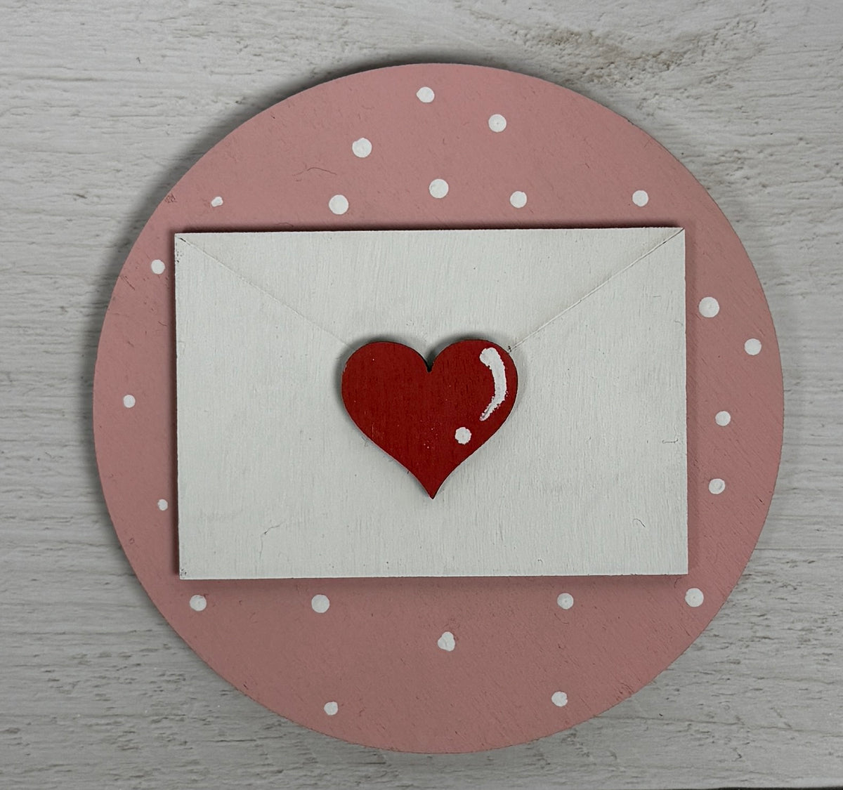 a white envelope with a red heart on it