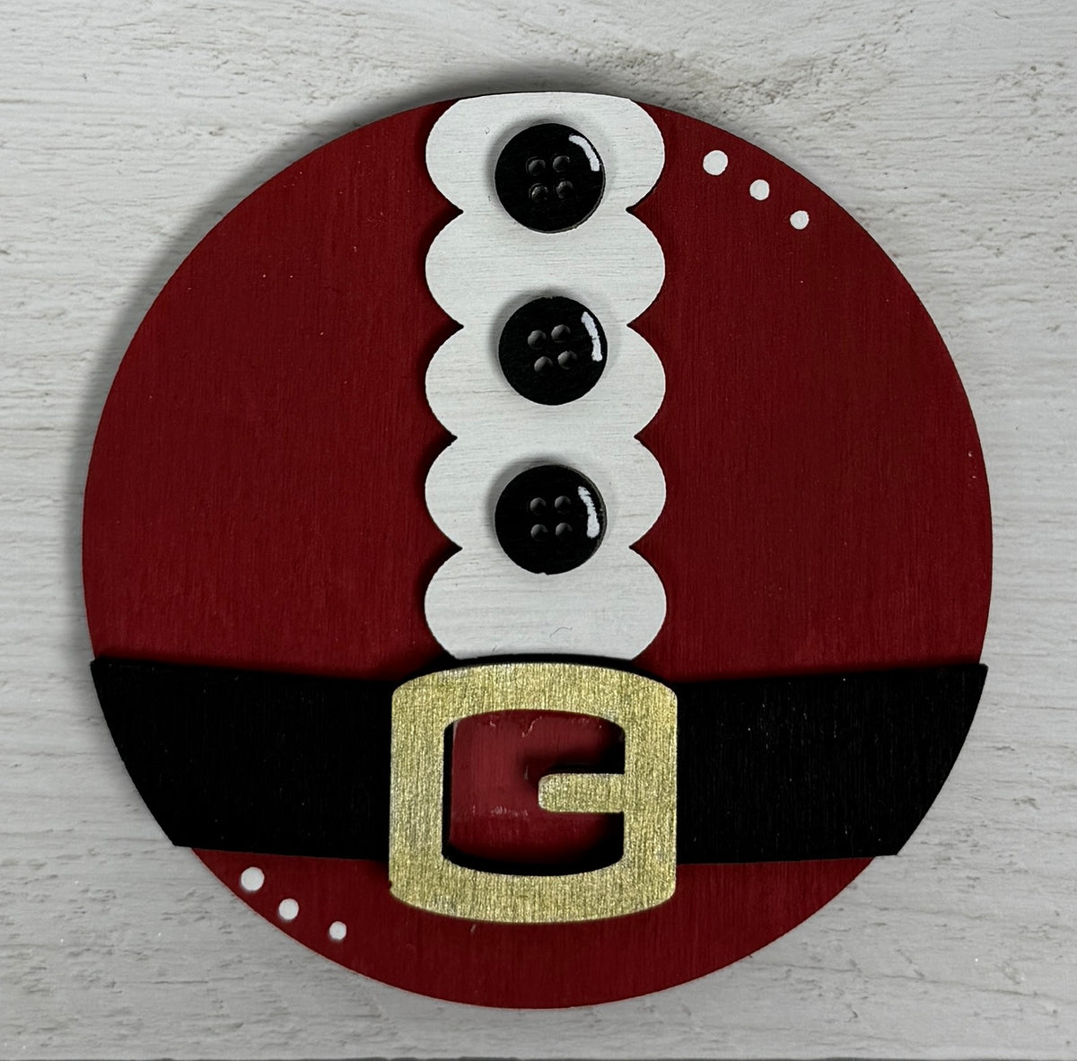 a red circle with a white and black belt and a gold buckle