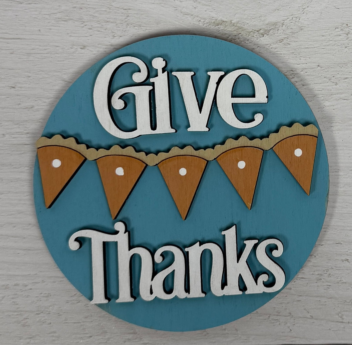 a blue circle with white text and a bunting banner on it