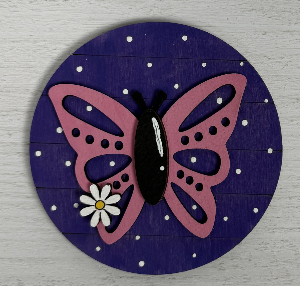 a butterfly and flower on a blue circle