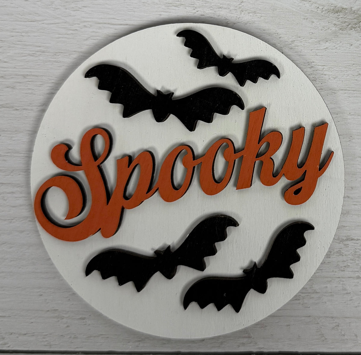 a white circle with black bats on it