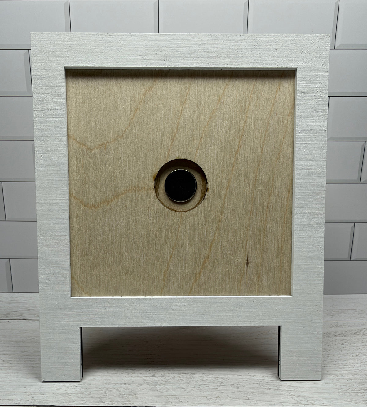 a white square box with a hole in it