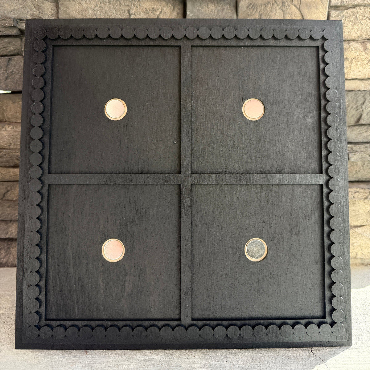 a black square object with circles on it