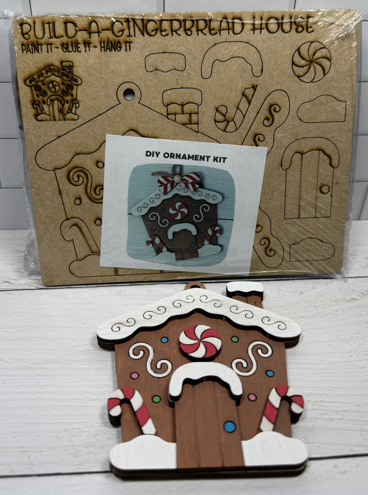 a wooden gingerbread house and a diy ornament kit