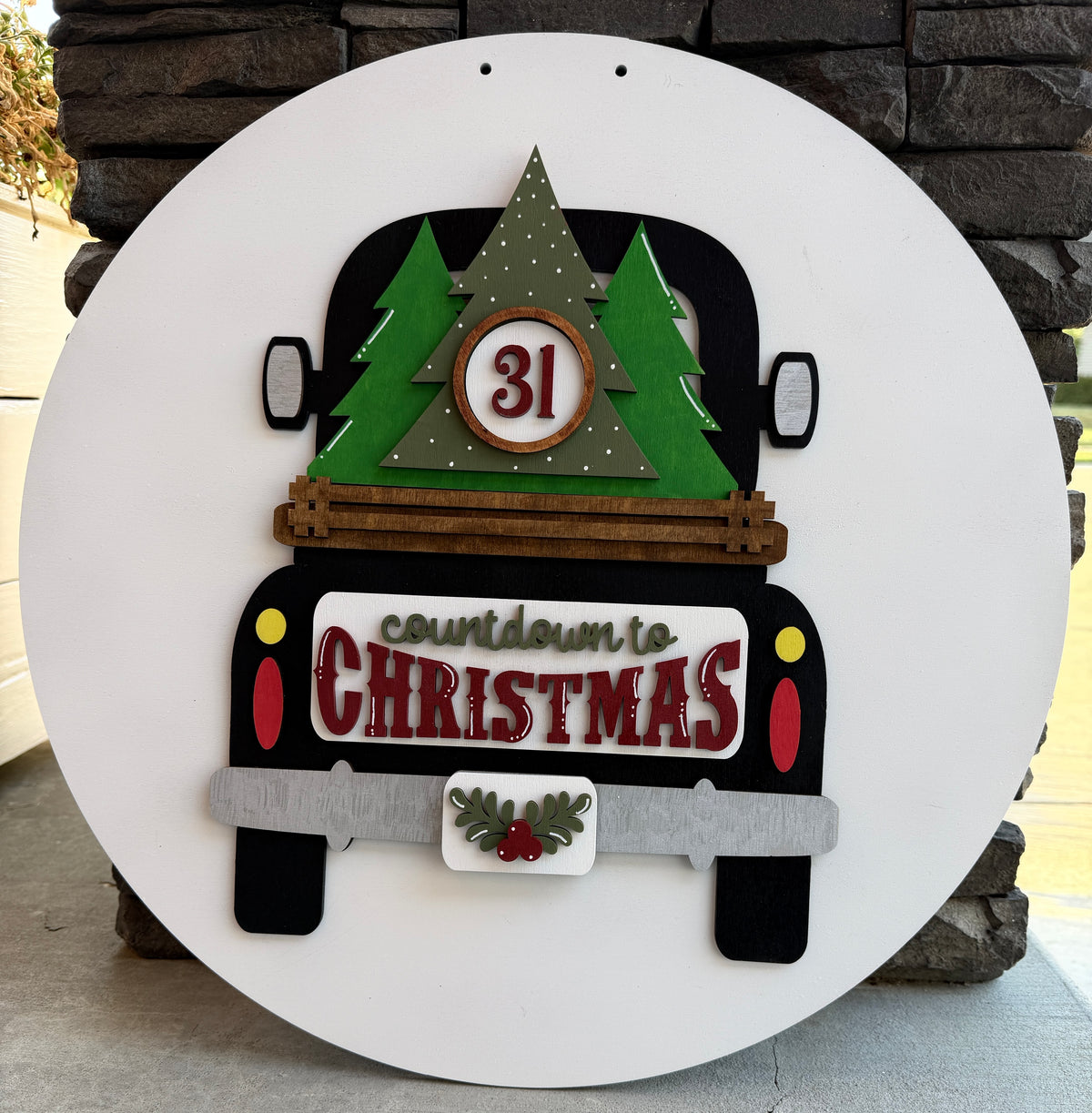 a sign with a truck and trees on it