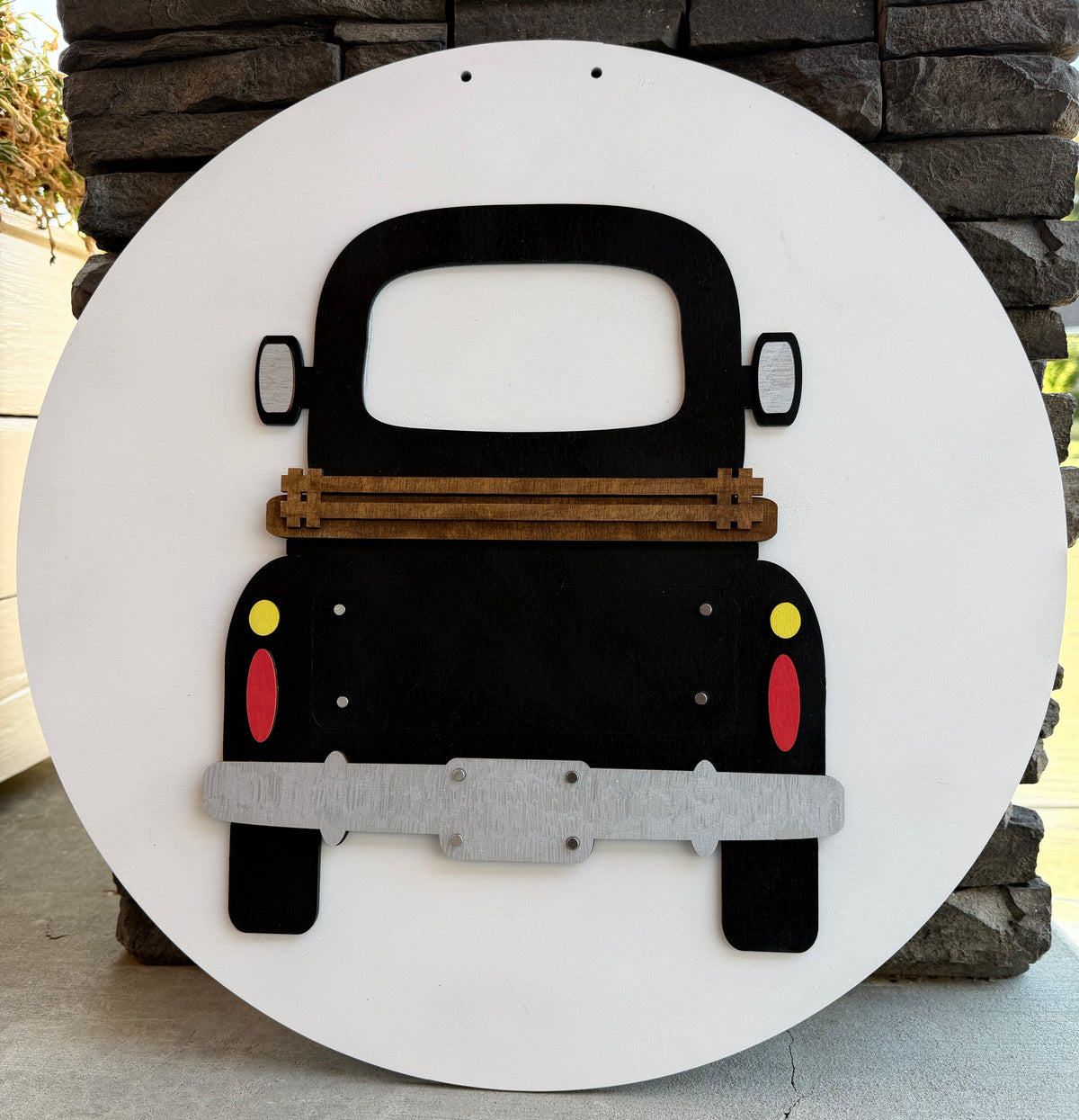a black truck on a white circle