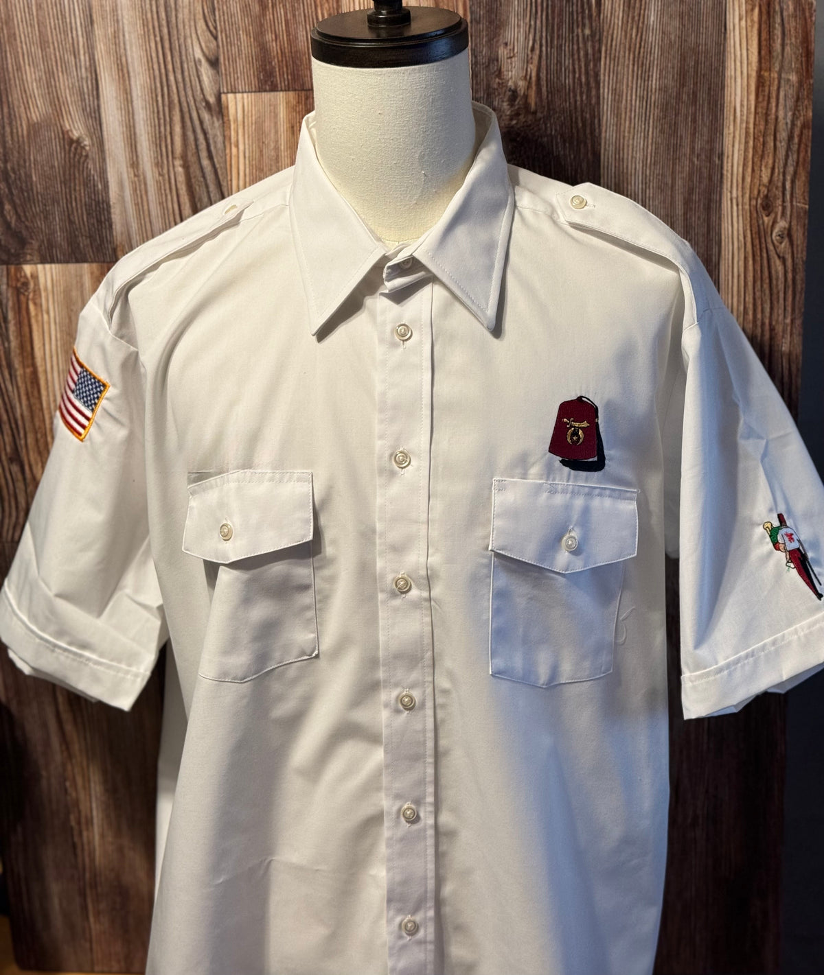 a white shirt with a flag patch on it
