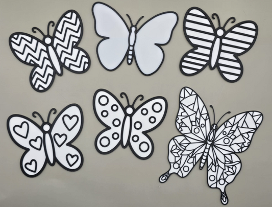 a group of butterflies on a gray surface